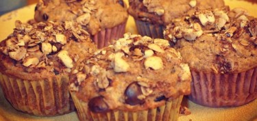 muffins crusted with nuts and melting chocolate chips.