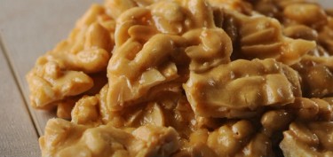 small pieces of stacked peanut brittles.