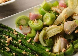 asparagus covered in peanuts bits and a red onion with leek salad.