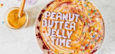 a top view of a cake with the words peanut butter jelly time made with frosting.