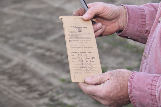 a man holding a paper form about soil sample
