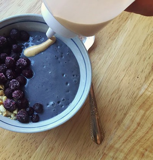 smoothie topped with blueberries and diced peanuts