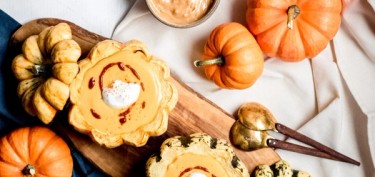 small pumpkin with the top cut out and filled with a creamy sauce.