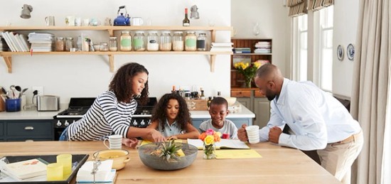 a family gathered around a kitchen table.
