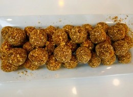 A plate full of balls made of banana and peanut butter.