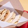 A delighful dish featuring a warm tortilla filled with creamy peanut butter, sliced bananas and a drizzle of honey.