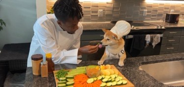 a man cooking with his dog