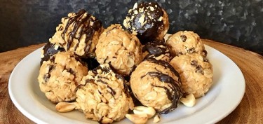 big balls made of oats and peanuts drizzled in chocolate.