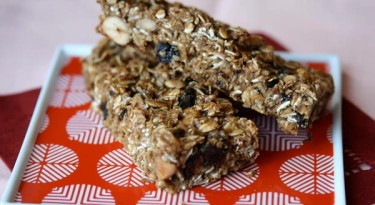 two granola bars on a red and white plate.