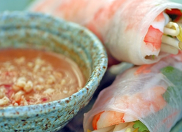 rice rolls with shrimps and a spicy dip bowl on the side.