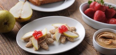 star shaped bread topped with pear slices and strawberry jam.