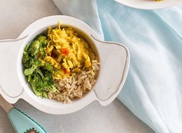 a kids bowl full of rice, broccoli and shredded chicken.