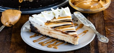 a big slice of cheesecake drizzled with chocolate and panut butter.