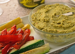 bowl of edamame hummus and roasted vegetables on the side.