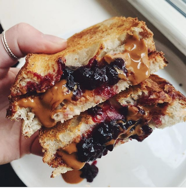 A toast filled with lots of peanut butter and jelly.
