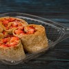 a plastic container filled with PB&J wraps.