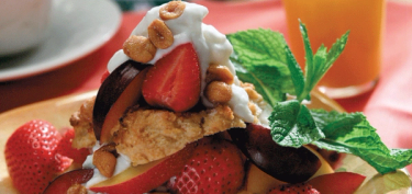 a dessert topped with strawberries and peanuts.