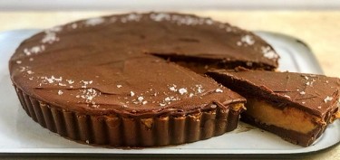 a chocolate pie with a slice cut out of it.