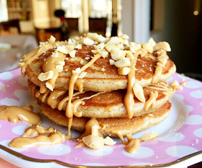 stacked pancakes drizzled in peanut butter