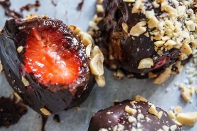 strawberry covered in chocolate and bits of peanut