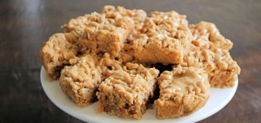 a plate with oatmeal bars and peanut butter topping.