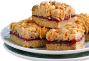 a plate with a stack of peanut butter and jelly bars.
