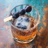 old fashioned drink with berries on top