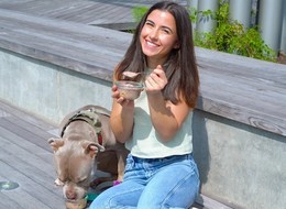 girl sharing ice cream with her dog