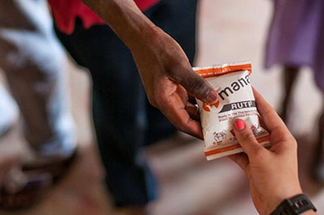 a person handing a bag of MANA to someone.