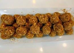 A plate full of balls made of banana and peanut butter.