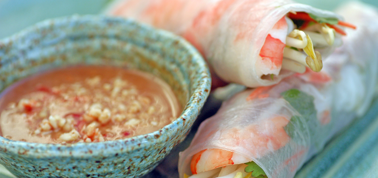 rice rolls with shrimps and a spicy dip bowl on the side.