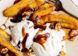 delicious banana dessert topped with ice cream and nuts.