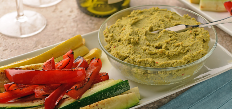 bowl of edamame hummus and roasted vegetables on the side.