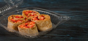 a plastic container filled with PB&J wraps.