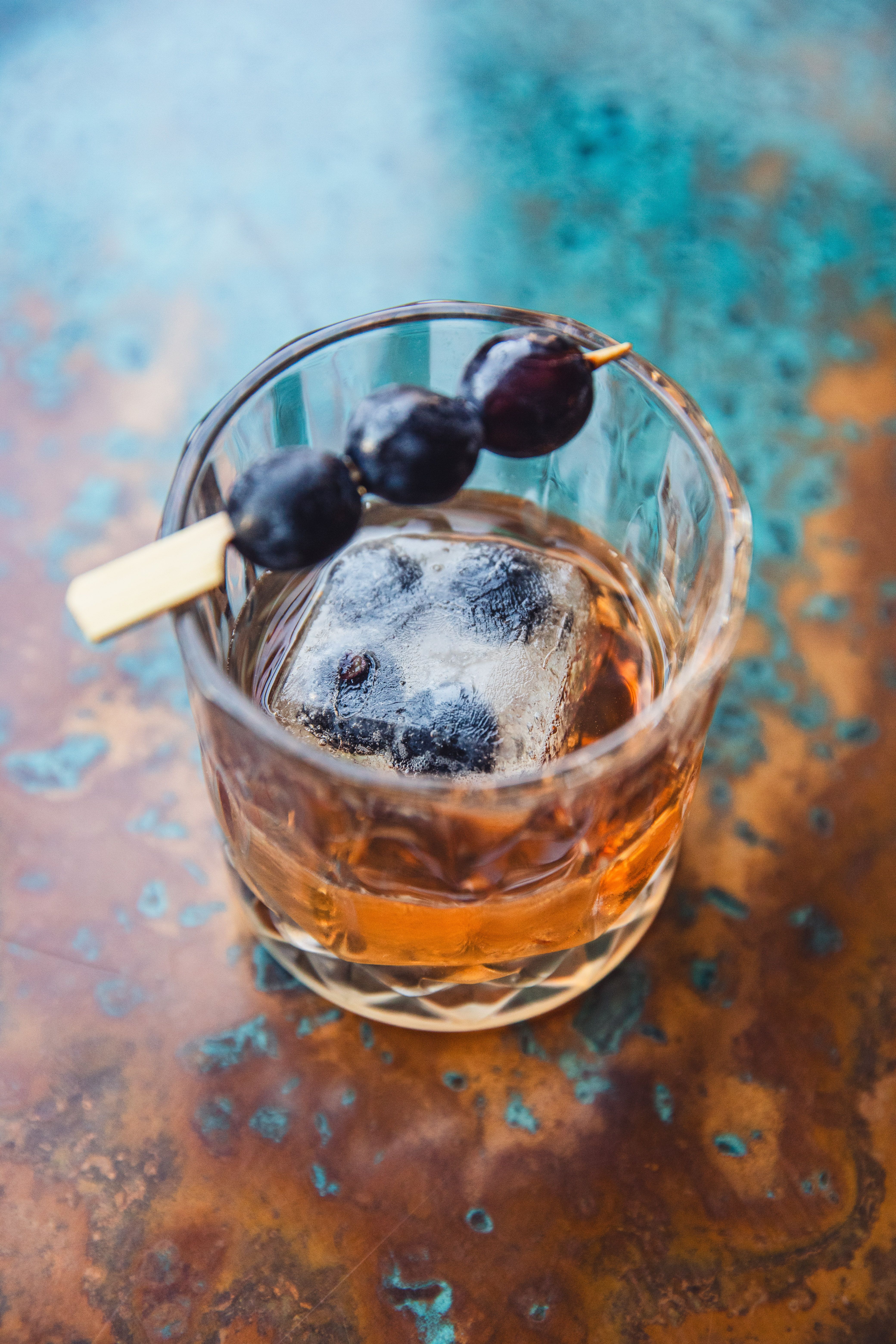 old fashioned drink with berries on top