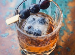old fashioned drink with berries on top