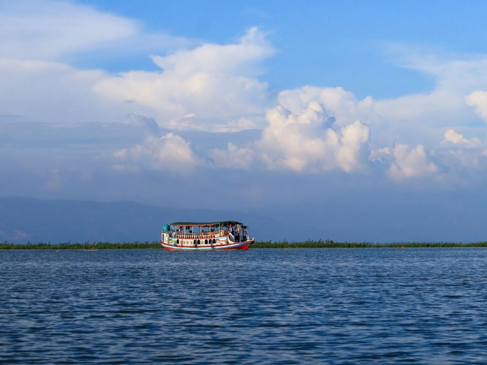 A boat crossing a haor wetland in Sunamganj