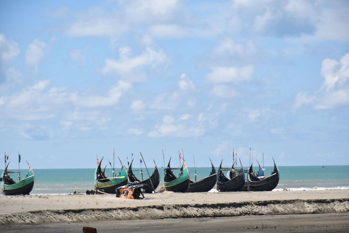 Long sandy beach at Cox's Bazar with gentle waves at sunset