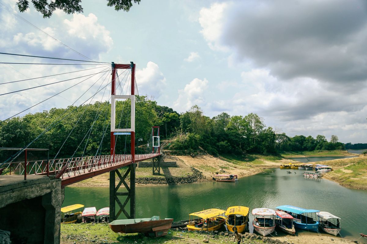 Boat on Kaptai Lake among green hills near Rangamati