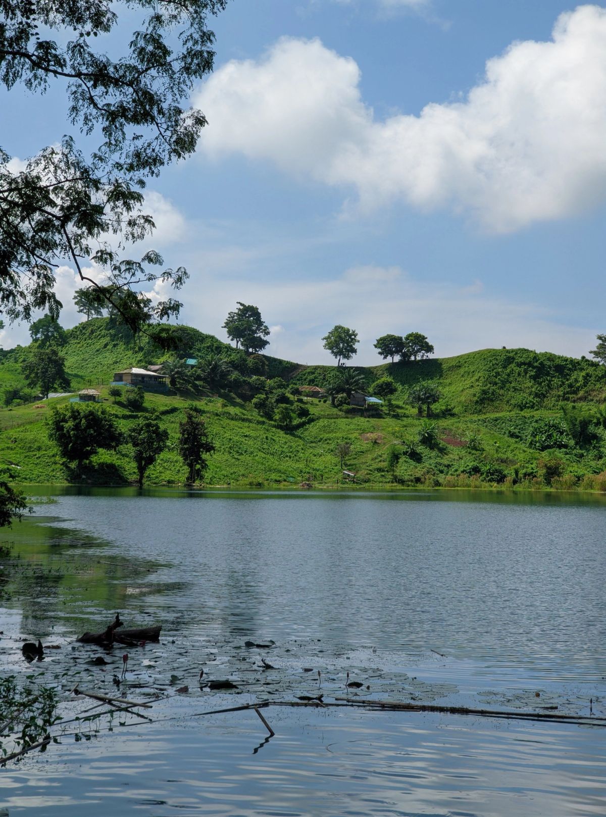 Green Bandarban hills rolling into the distance under drifting clouds