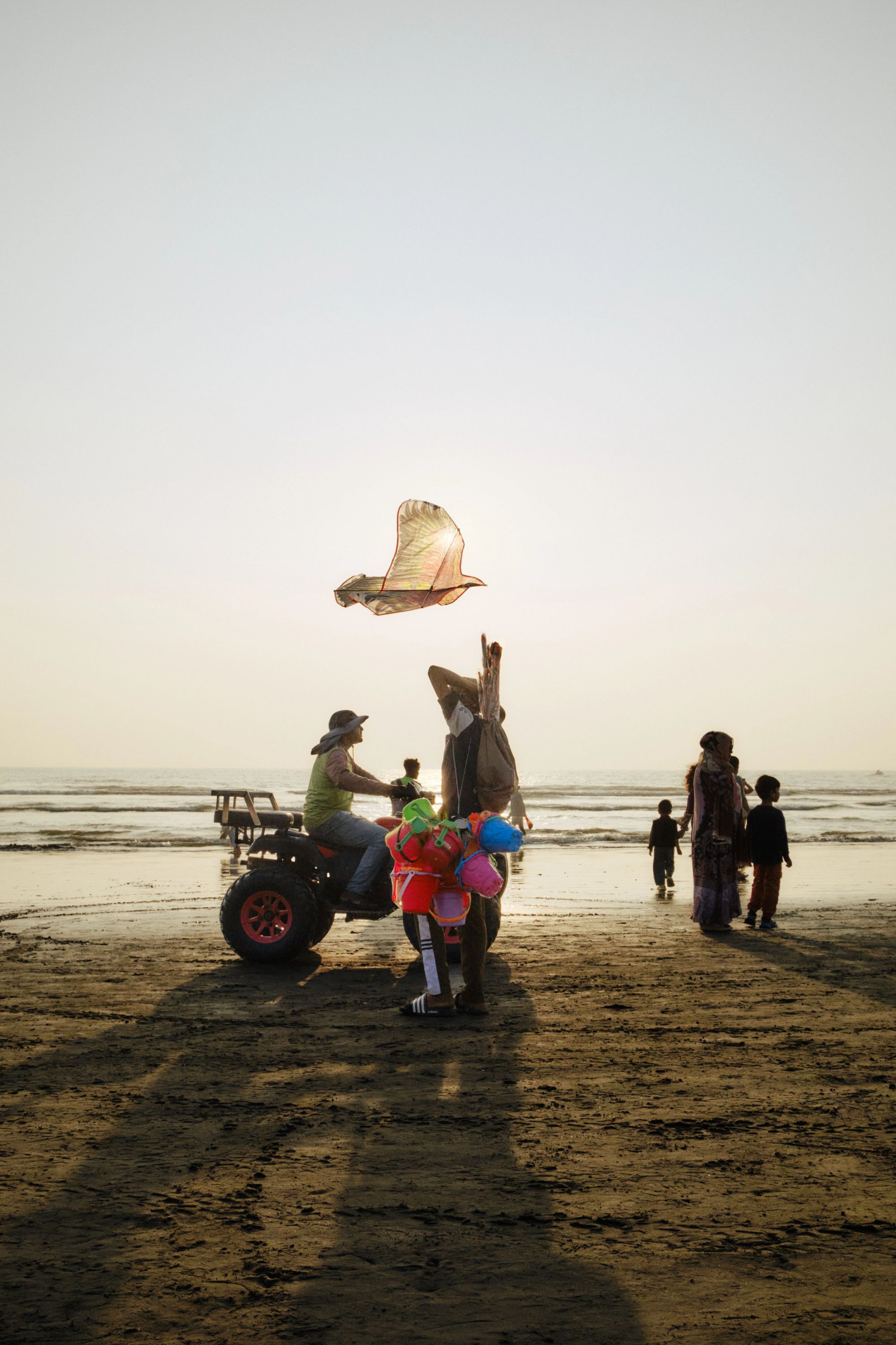 Family with young children playing on the sand at Cox's Bazar beach
