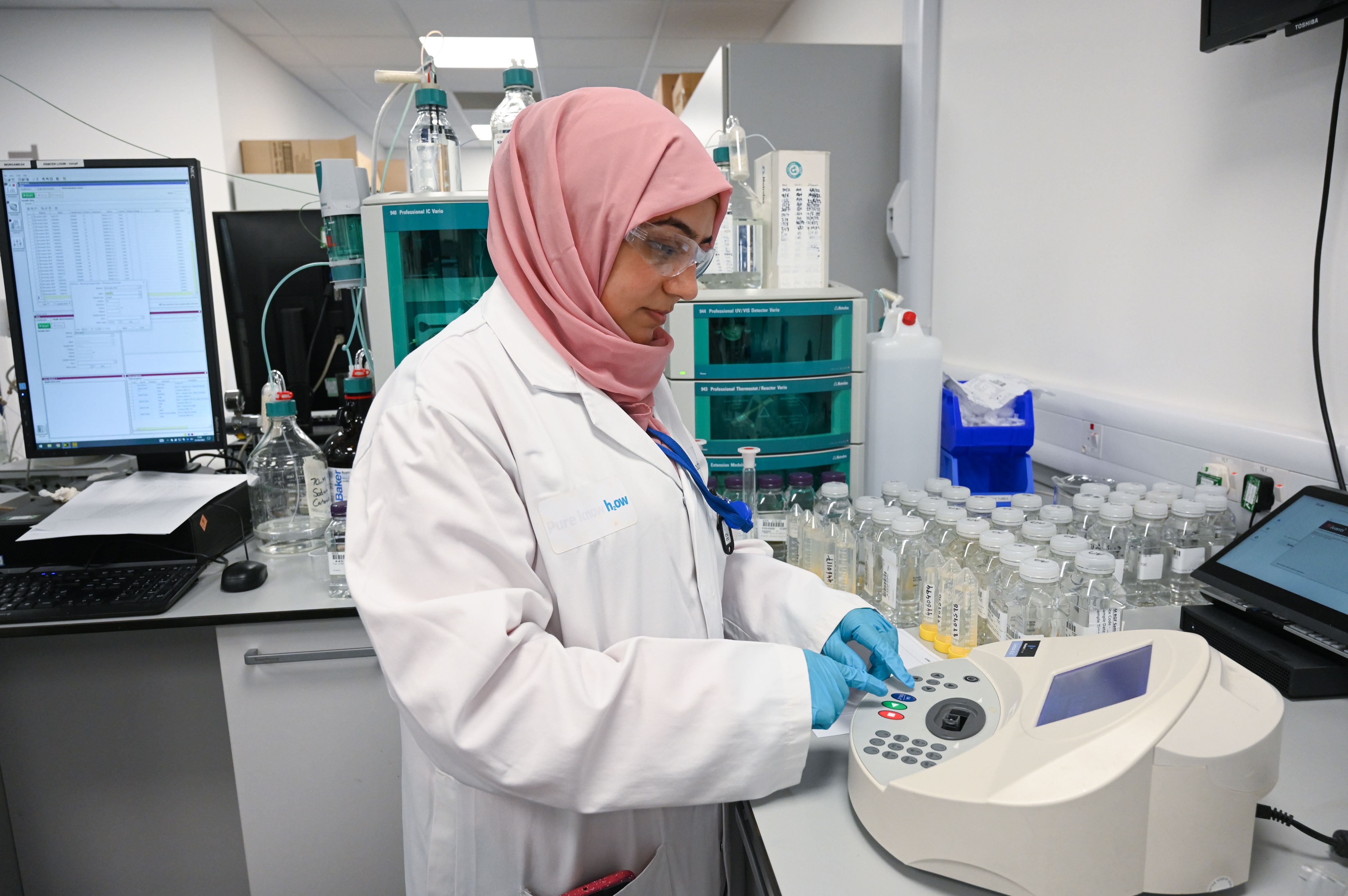 Photograph of a scientist using machinery to sample water.