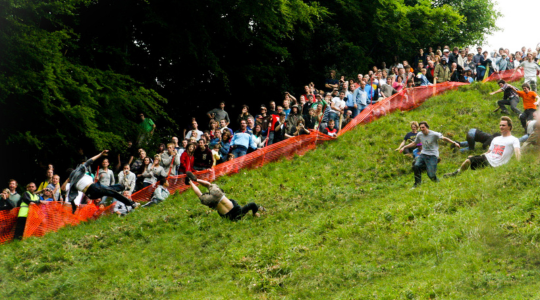 People competing in the traditional Cheese Rolling competition, one fo Britain's weird traditions