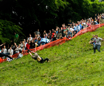 People competing in the traditional Cheese Rolling competition, one fo Britain's weird traditions