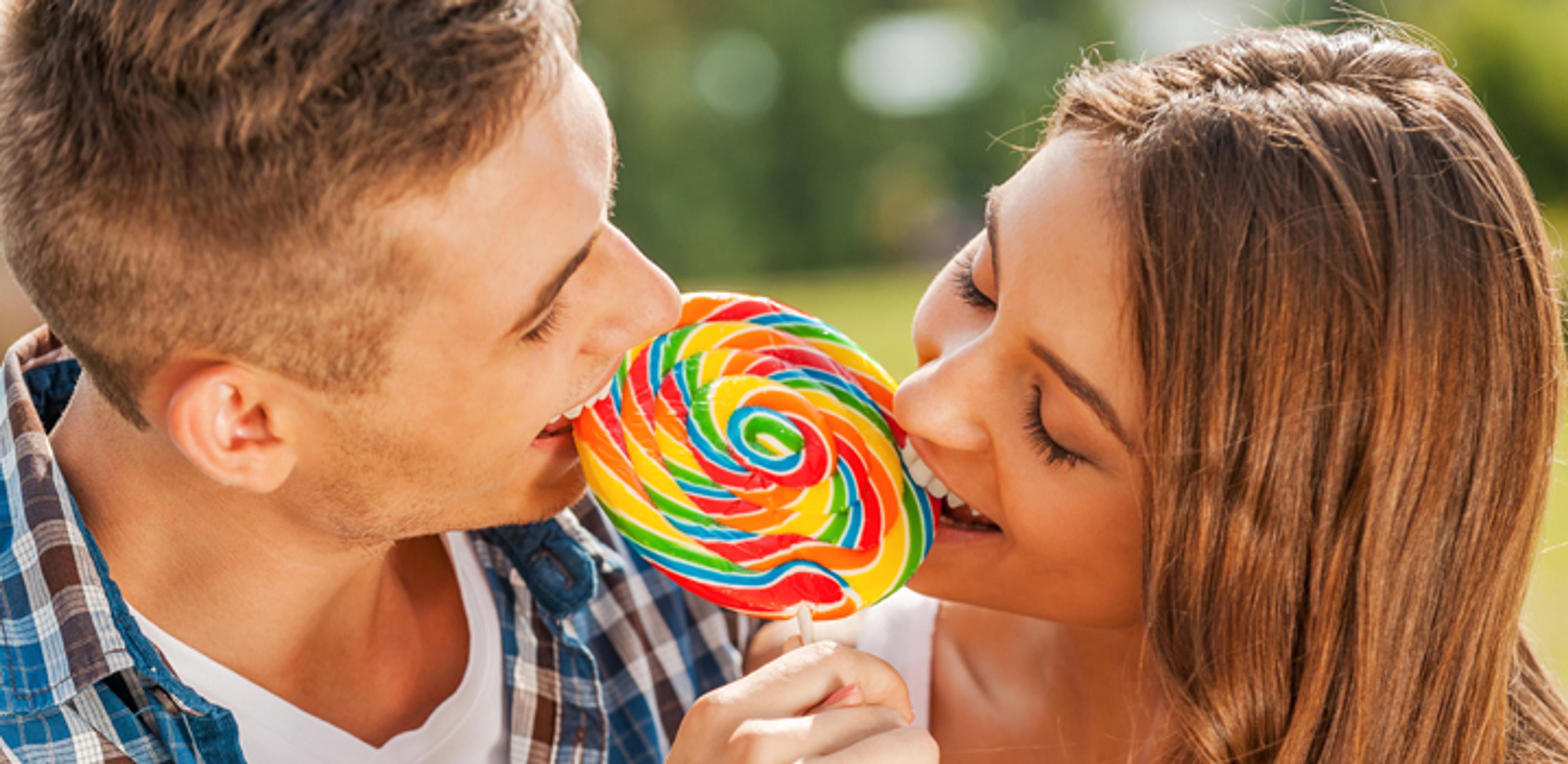 Couple sharing lollypop