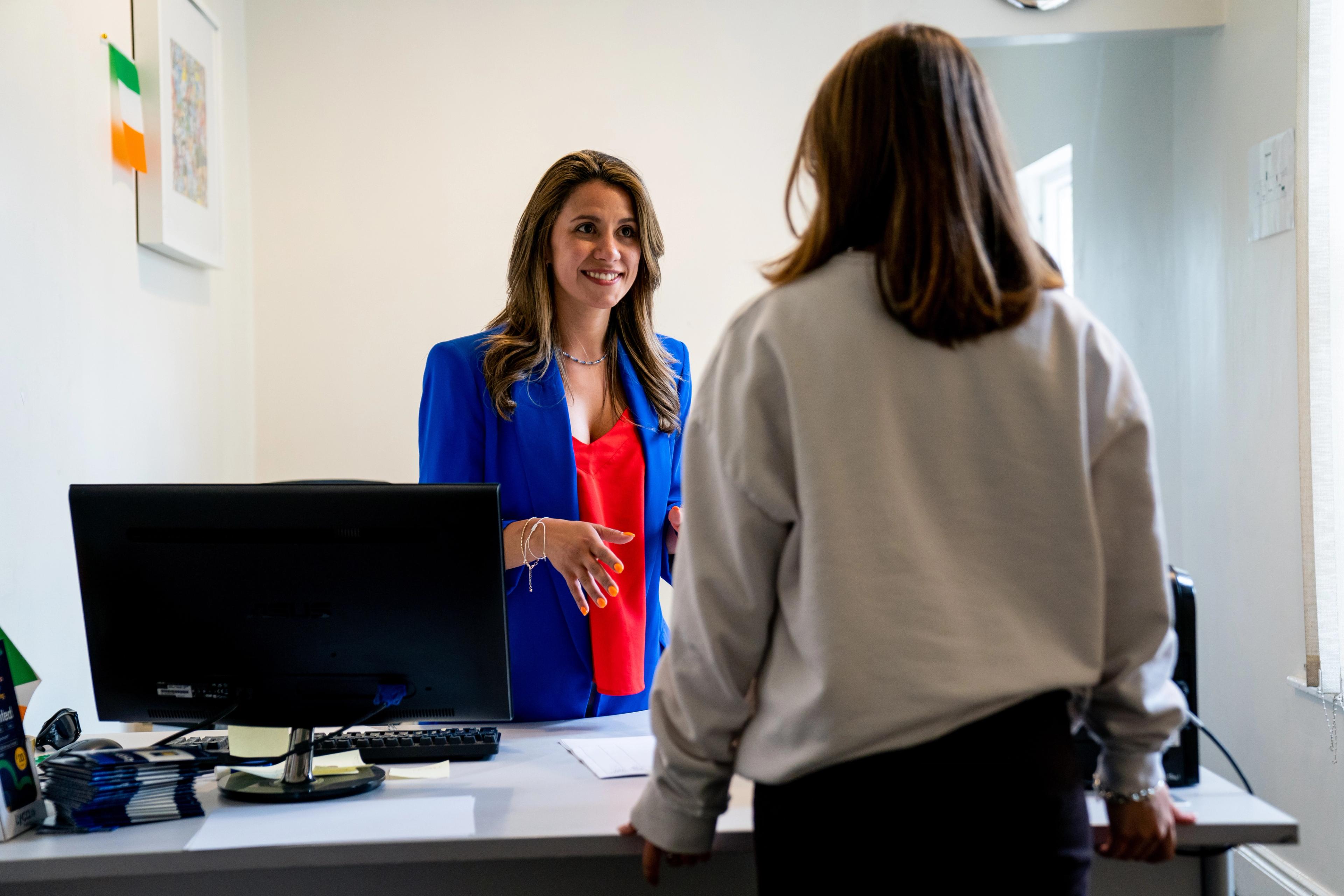 Student talking to teacher at reception