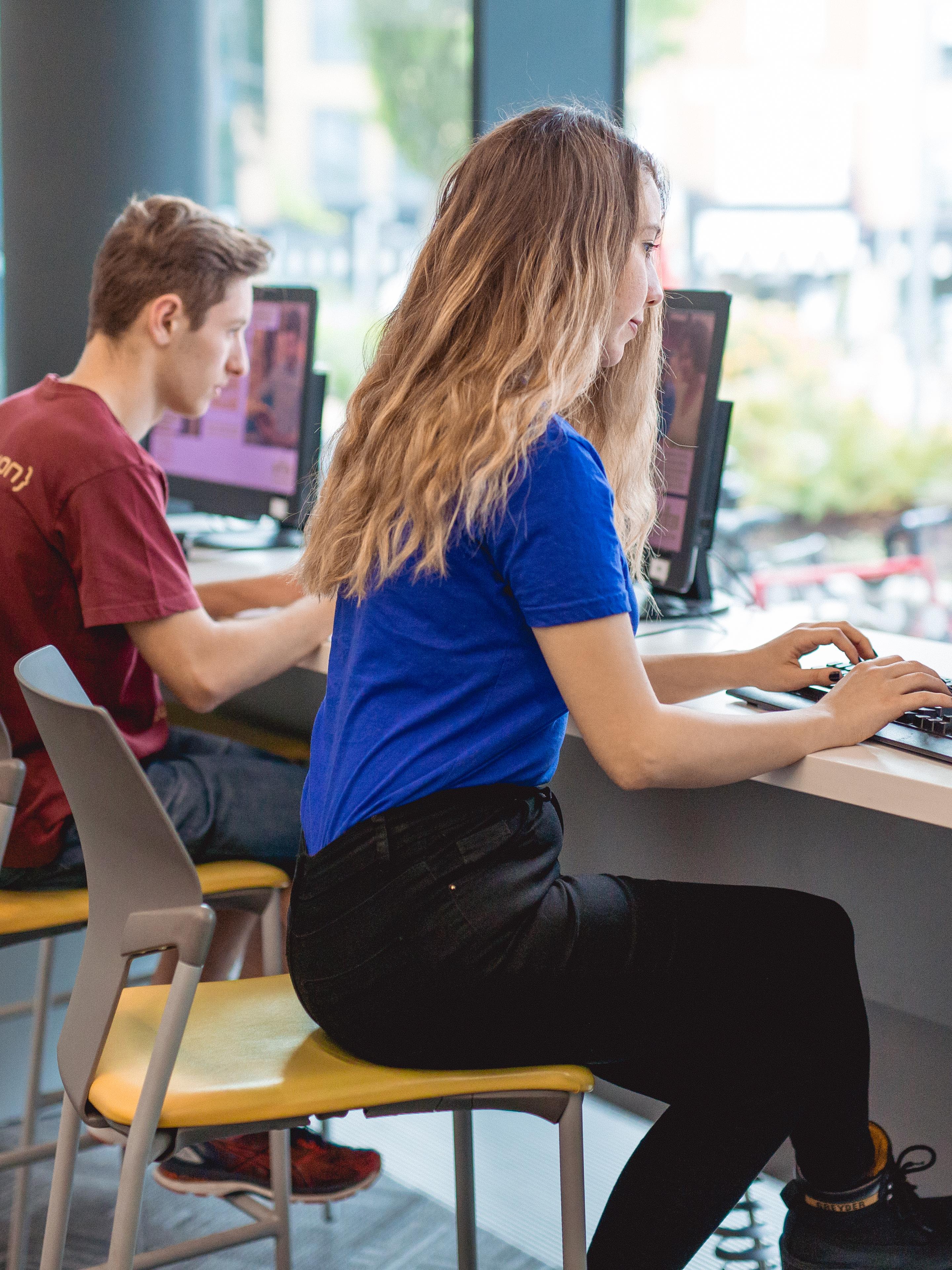 Students accessing computers in pubic library
