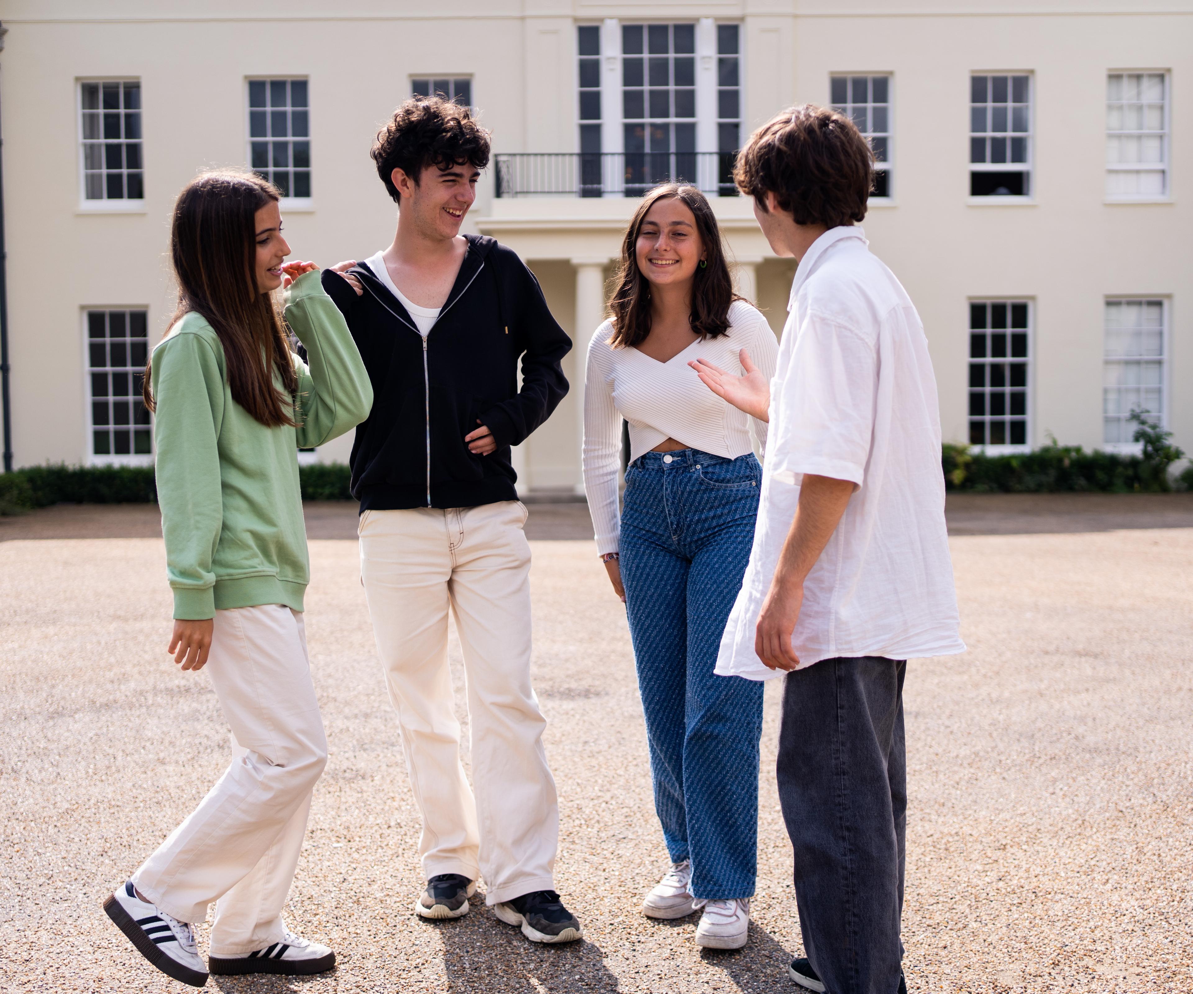 Group of junior students outside building talking