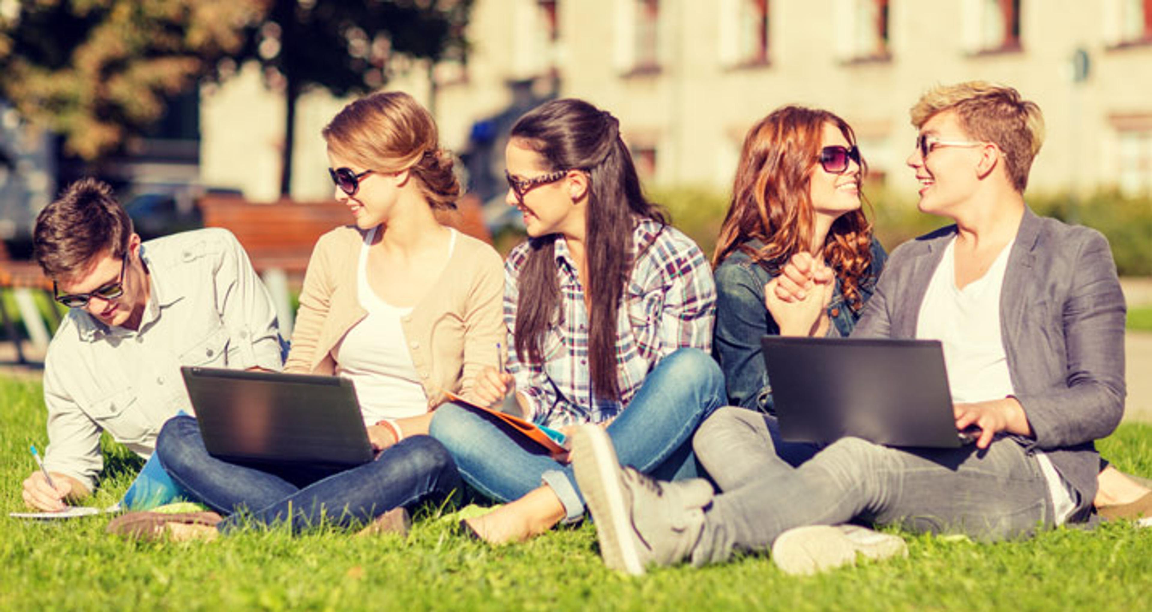 Students studying on the grass outside