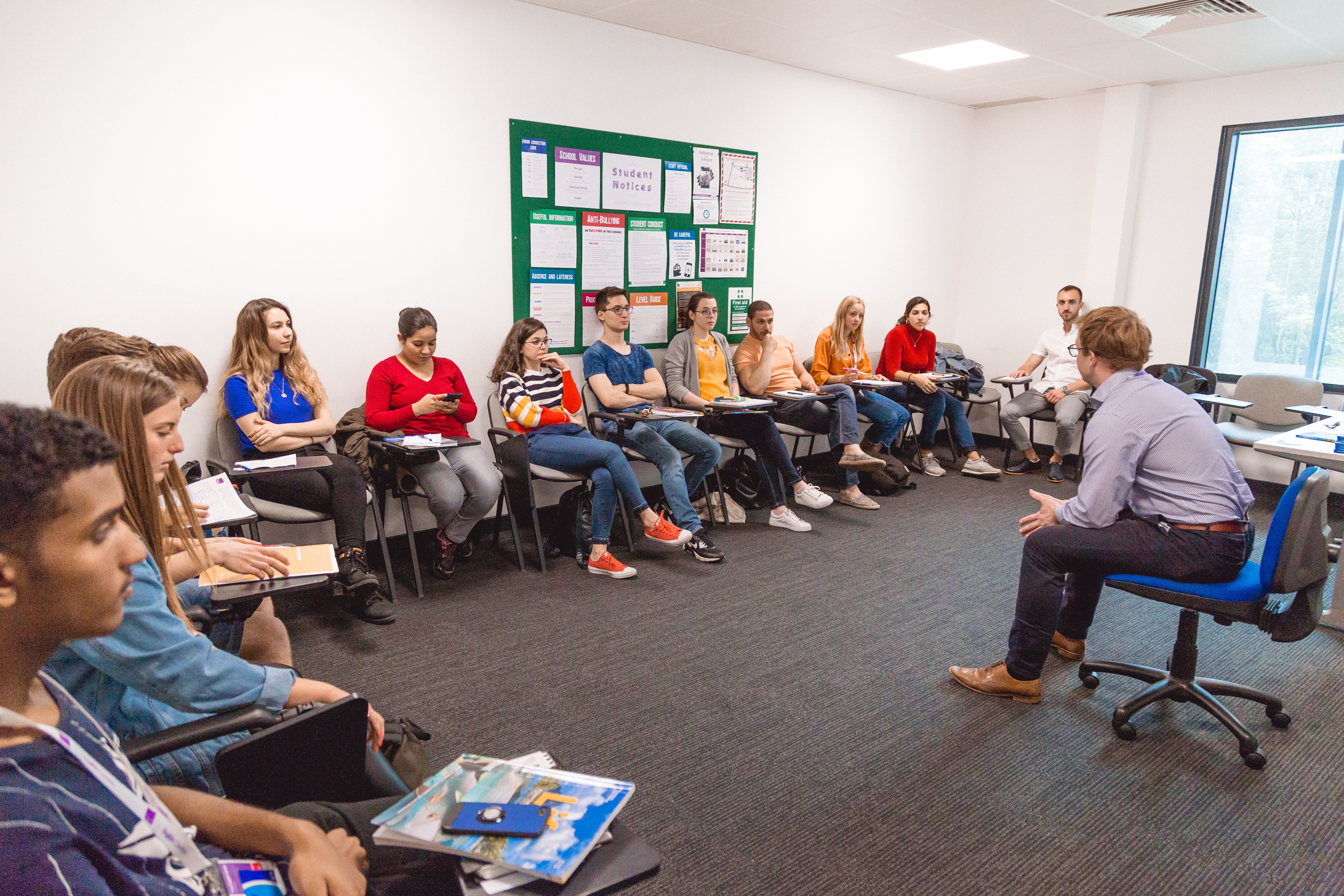 Twin students in classroom with teacher